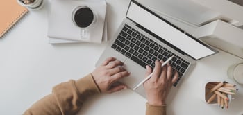 Canva - Working Man Is Typing on Black Frame Laptop