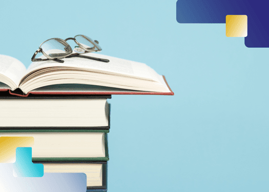 Stack of books with reading glasses on top