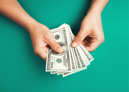 Green background with hands counting money