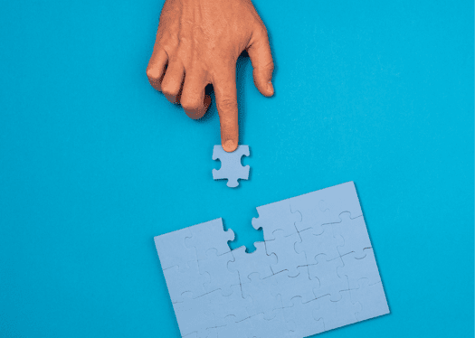 Blue background with puzzle getting final piece placed