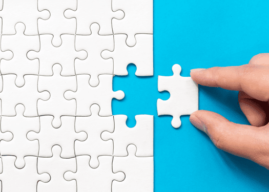 A missing puzzle piece being fit into a puzzle