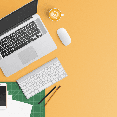 Top down view of a desk layout with yellow background
