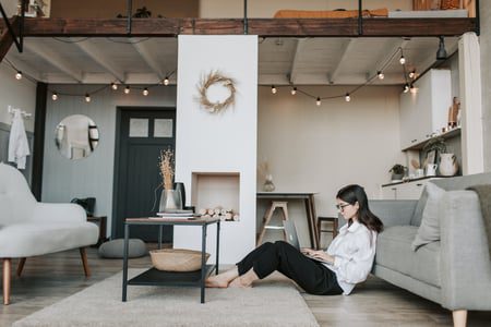 woman sitting on floor with laptop